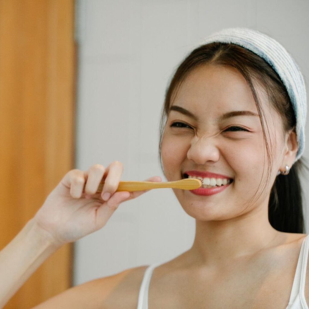 woman brushing her teeth