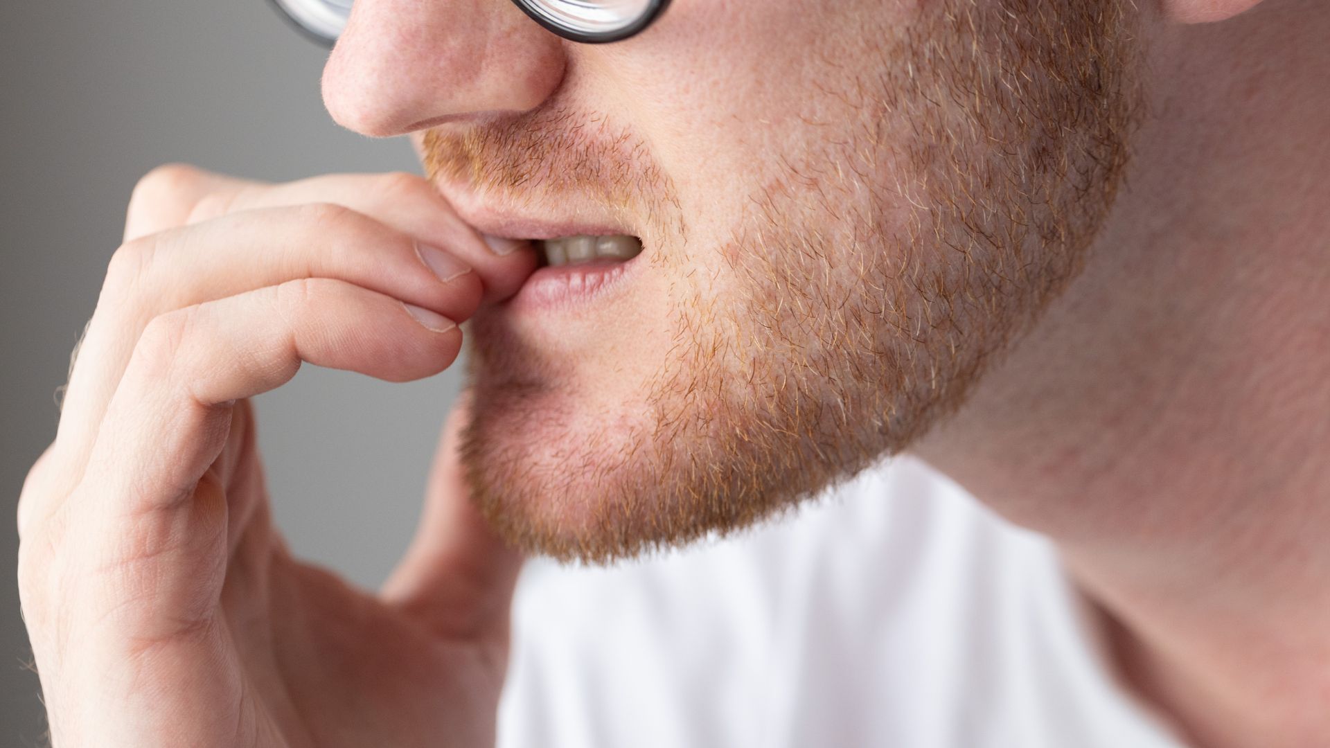man biting nails