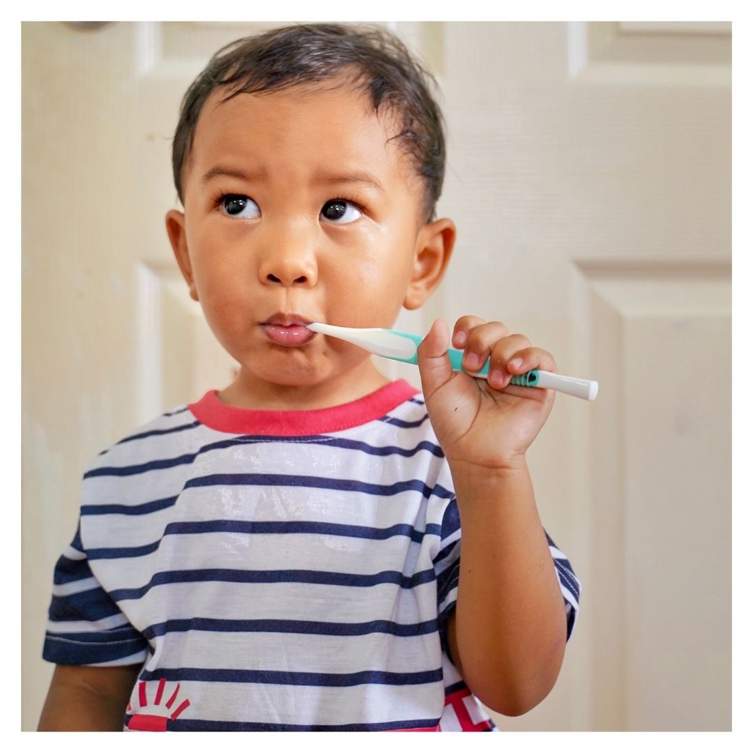 little boy brushing his teeth