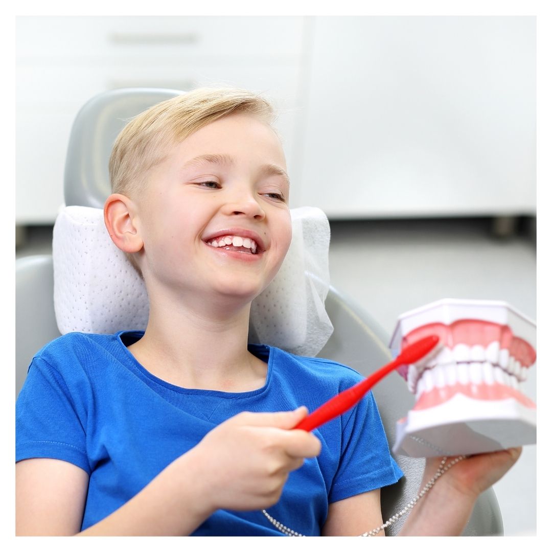 boy learning about proper tooth brushing techniques