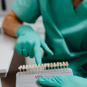 dentist points at dental veneer sample 