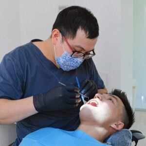 dentist cleaning patients teeth