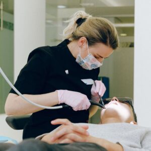 dental hygienist cleaning teeth