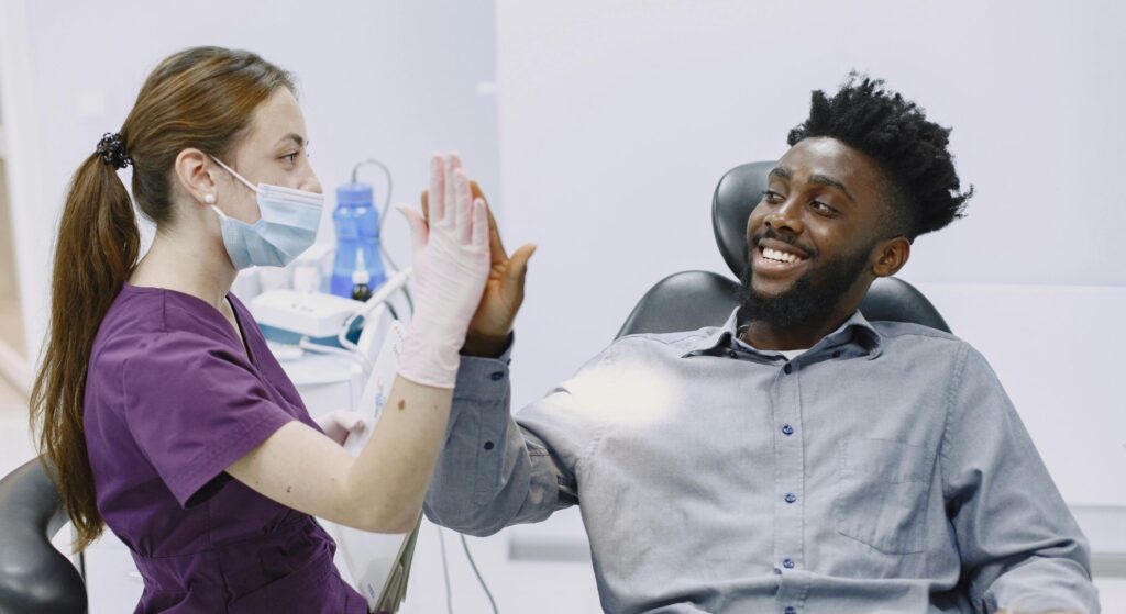 dentist and patient high-fiving