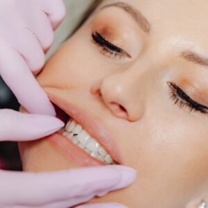 Dentist's hands in a client's mouth