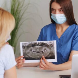 Dentist showing an X-ray to a client