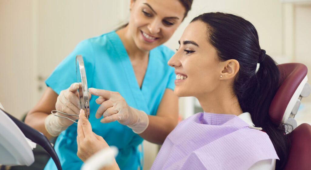 Dentist showing a woman her dental implant