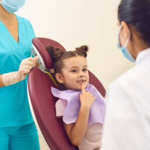 dentists talking with young girl