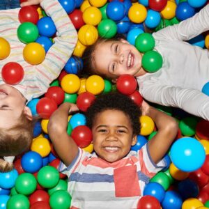 Kids smiling in ball pit