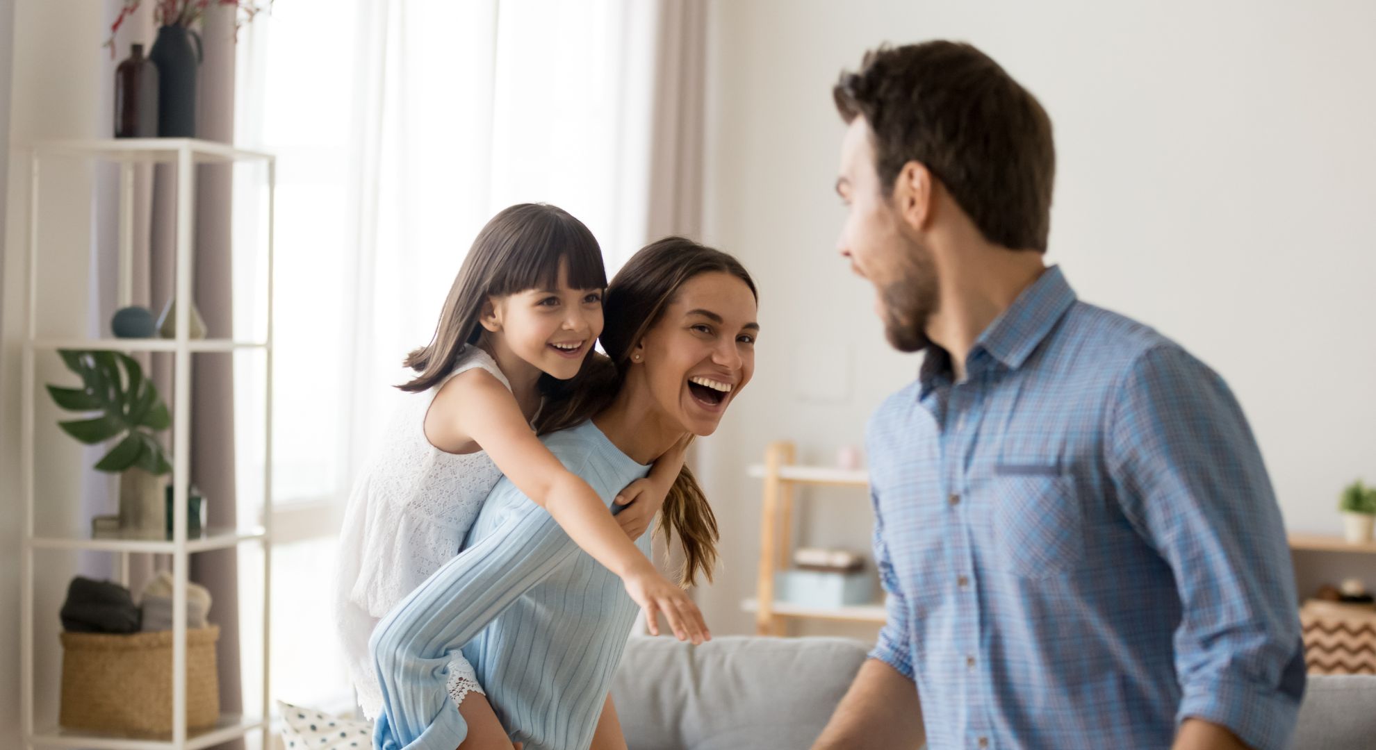 Family with young kid playing at home